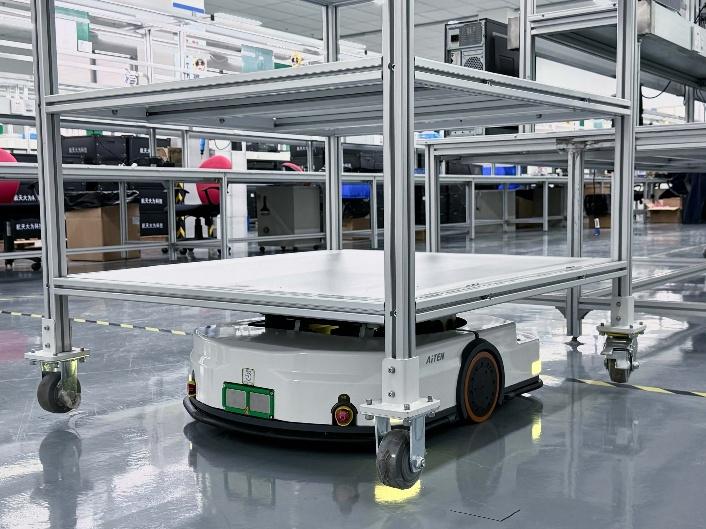 Autonomous mobile robot underneath a multi-tier parts cart