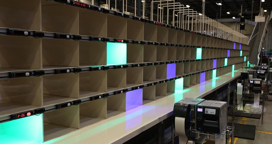 Put wall with rows of cubbies and colored lights marking order positions